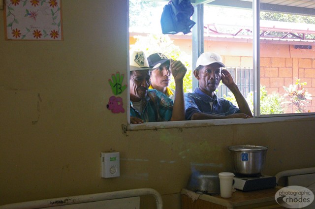 These men were peaking in the window watching the activities at the cancer center